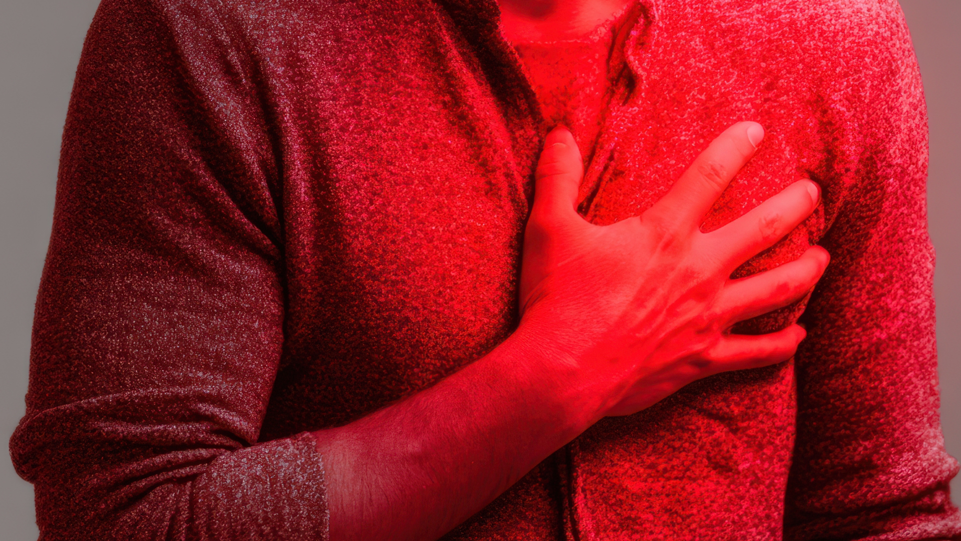 a close up of a red substance on a black background